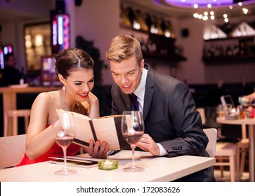 Couple reading menu together and choosing meal