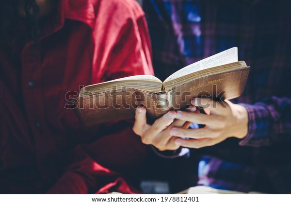 A couple  reading and study bible in home and\
pray together.Christian\
concept.