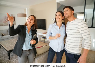 Couple With Real-estate Agent Visiting House For Sale