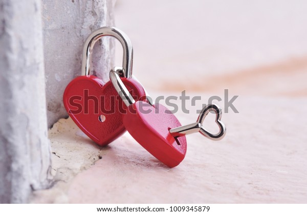 Couple red heart lock with key  lean against\
vintage pole, valentine love\
symbol