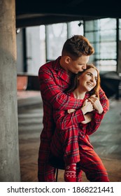 Couple In Red Pyjamas On Christmas