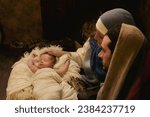 Couple reenacting a Christmas live nativity scene with their 8 days old little newborn baby