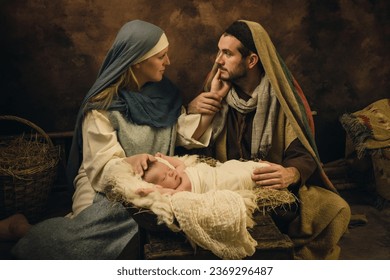 Couple reenacting a Christmas live nativity scene with their 8 days old little newborn baby