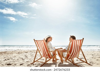 Couple, relax and beach chairs with umbrella on sand for vacation, holiday or weekend break. Summer, man and woman together in nature with water for peace, travel or tourism in bali getaway with view - Powered by Shutterstock