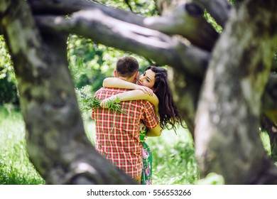 couple relax in green garden. Lovely couple walk in green meadow. - Shutterstock ID 556553266