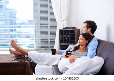 Couple relax at home with cup of coffee and sofa couch. happy healthy relationship
