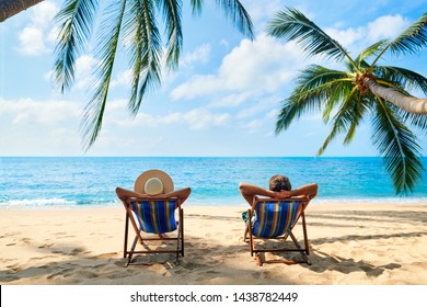 Couple relax on the beach enjoy beautiful sea on the tropical island. Summer beach vacation concept        