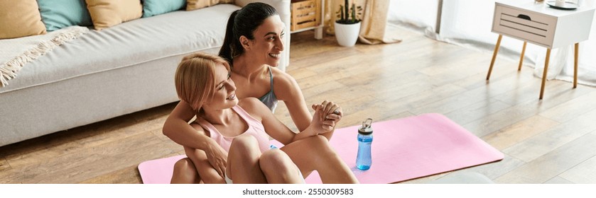 A couple relaxes on yoga mats, smiling and supporting each other during a workout session. - Powered by Shutterstock