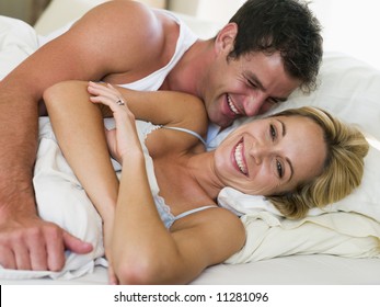 Couple Relaxing In Bed