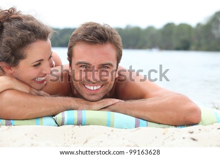 Couple relaxing by the lake