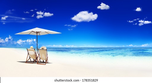 Couple Relaxing in Deck Chairs at Beach