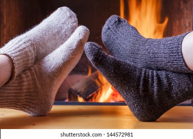 couple relaxing at the fireplace on winter evening