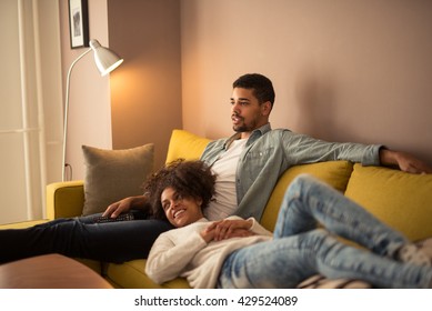 Couple Relaxing At Home And Watching Tv Together.