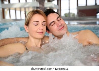 Couple relaxing in jacuzzi of spa center