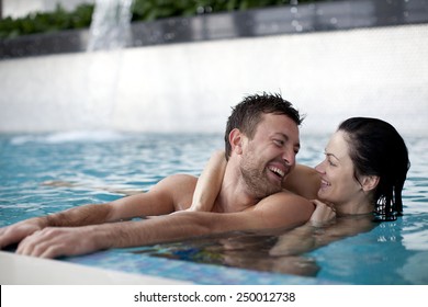Couple relaxing in jacuzzi of spa center 