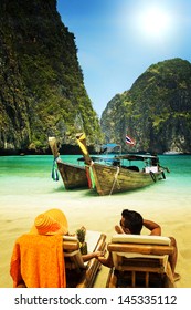 Couple relaxing Maya bay Phi Phi Leh island, Thailand