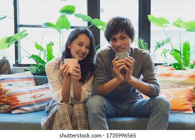 Couple Relaxing On The Sofa