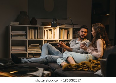 Couple Relaxing On Sofa At Home