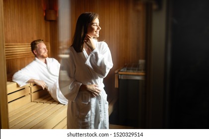 Couple relaxing, resting and sweating in sauna - Powered by Shutterstock