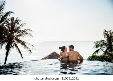 Couple relaxing in a swimming pool - Powered by Shutterstock