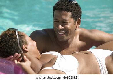 Couple Relaxing In Swimming Pool