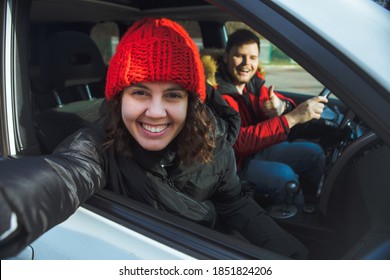 Couple In Rent Car Smiling Woman In Red Winter Hat