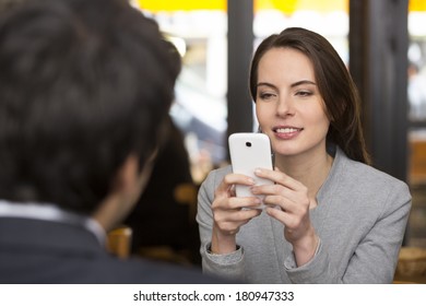 Couple In Restaurant , Woman Is On The Phone, Sms, Surfing Web