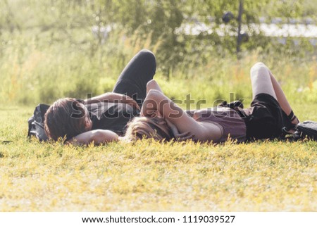 A couple is resting on a lawn in the center of Moscow