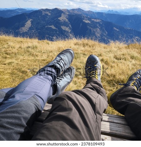 couple resting on a relax chair in the mountains, Austrian alps 