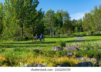 Couple Resting In Reykjavik Botanical Garden, Iceland. Date 2. June 2020