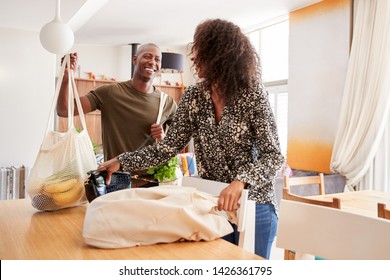 Couple Returning Home From Shopping Trip Unpacking Plastic Free Grocery Bags - Powered by Shutterstock