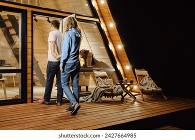 A couple returns to tiny log cabin late at night after a walk outdoors - Powered by Shutterstock