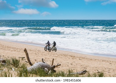 Couple Riding Bicycle Or Fat Bike On Sunny Beach