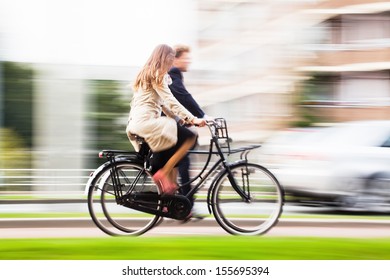 Couple Riding Bikes In The City With Motion Blur