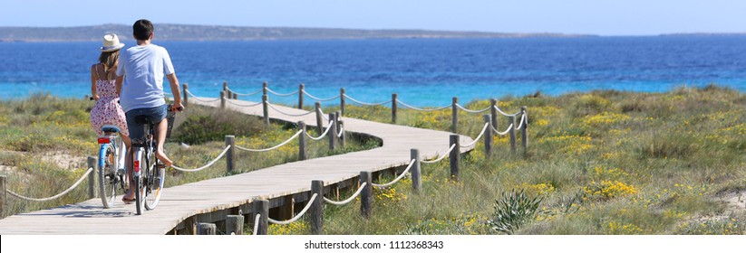 Couple riding bikes on Formentera Island, template - Powered by Shutterstock