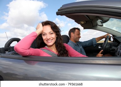 Couple Riding Convertible Car