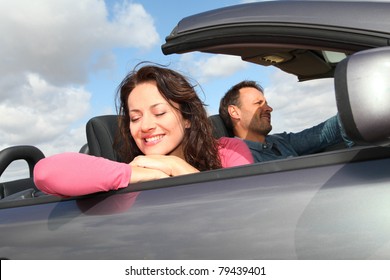 Couple Riding Convertible Car