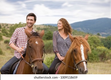 Couple Riding Horses