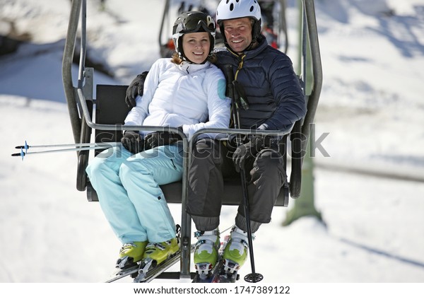 Couple riding on ski lift at
resort