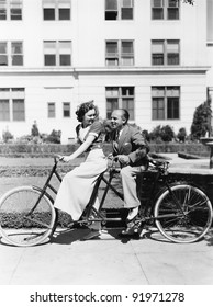 Couple Riding Tandem Bike