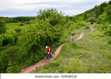 A couple riding their mountain bikes on single track trail in Ontario, Canada