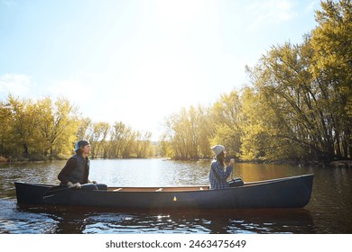 Couple, river and canoeing for forest travel at holiday camp site for relax journey, explore or adventure. Man, woman and rowing teamwork on lake in Colorado for weekend vacation, morning or autumn - Powered by Shutterstock