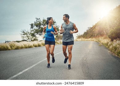 Couple, road and happy with running for fitness or training, support and love in California. Workout, exercise and people with jogging for health or wellness and wellbeing in morning with lens flare - Powered by Shutterstock