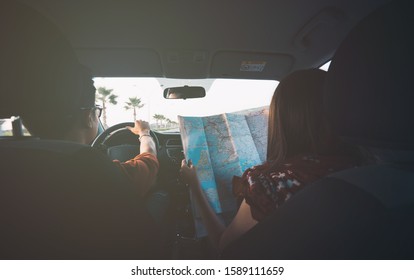 Couple Road Trip Background Image In Soft Tone Vintage Style. Happy Young Couple With A Map In The Car. Young Traveler Man And Woman Using Map To Find Roadtrip Destination. Lover Time Background.