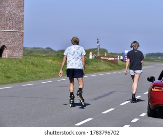 a couple rollerskating on the road