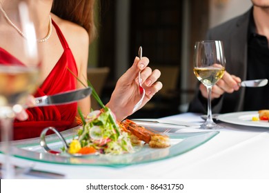 Couple for romantic Dinner or lunch in a gourmet restaurant drinking wine and eating - Powered by Shutterstock