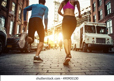 Couple running in Brooklyn. Urban runners on the move in New york