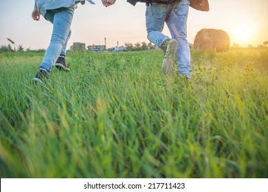 Couple Running In A Field