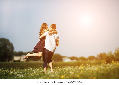 Couple Running In Field And Have Fun 