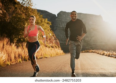 Couple, running and fitness on road by mountain with smile for speed, development and progress in morning. Man, woman and happy with diversity for training, exercise or workout for wellness in nature - Powered by Shutterstock